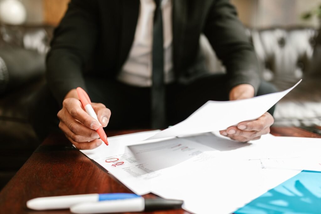 Professional reviewing and signing visa application documents on a desk, representing the Dubai domestic worker visa application process