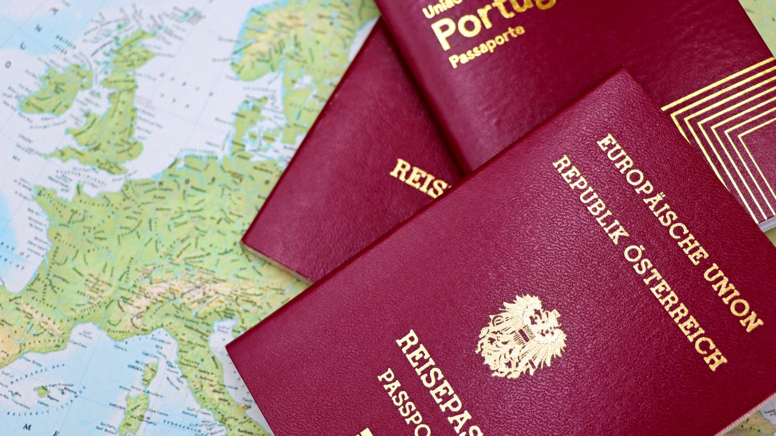 Passports laid out on a world map, representing the 2026 UAE Golden Visa expansion to new nominated categories