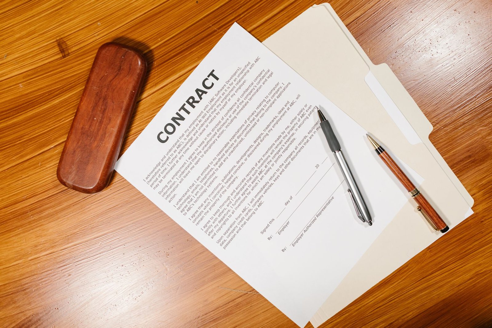 Close-up of a UAE employment contract document on a desk, representing probation, notice period and termination rules