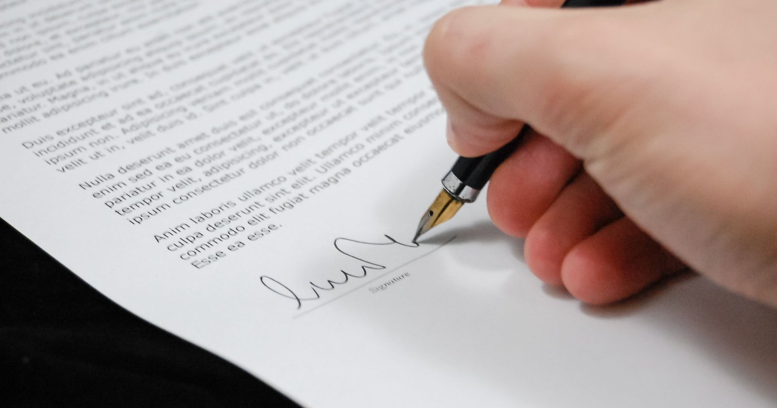 Legal documents being signed, representing wills registration and inheritance planning for expats in Dubai