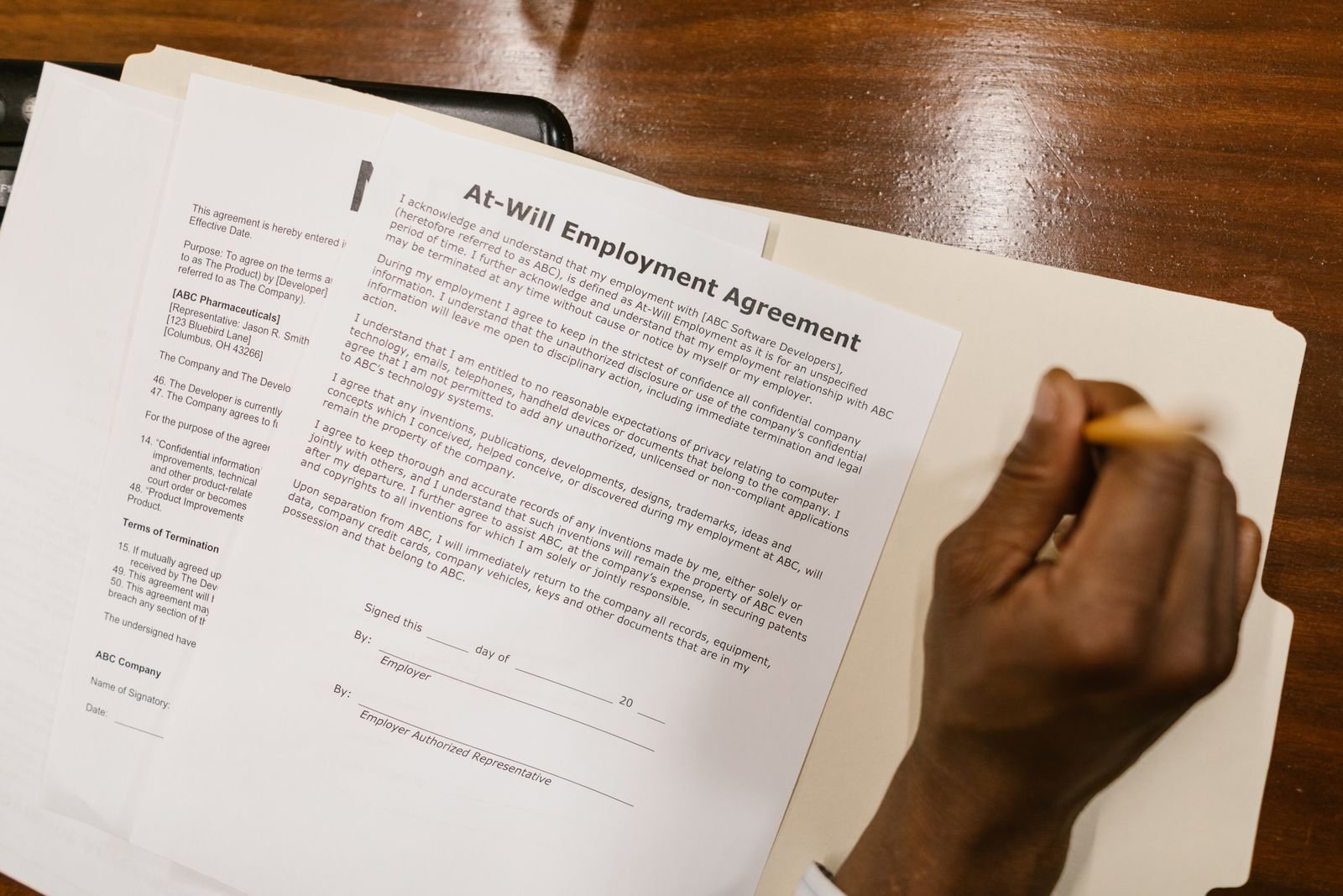 Employer and employee reviewing and signing an employment contract in the UAE