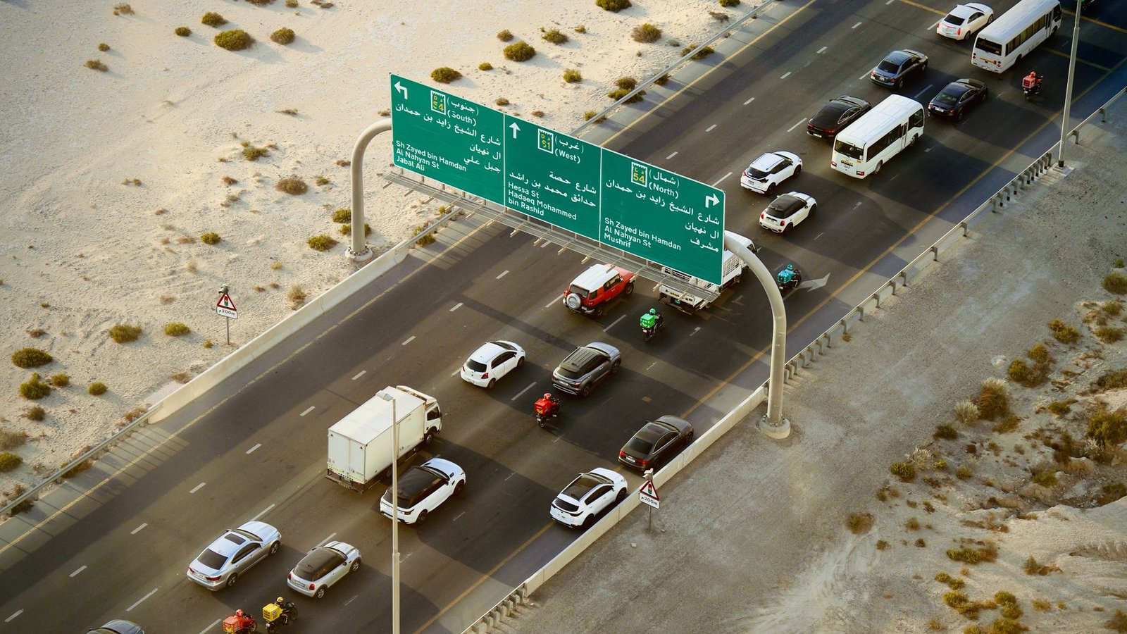 Aerial shot of vehicles on a busy Dubai highway, representing traffic fines affecting UAE visa renewal
