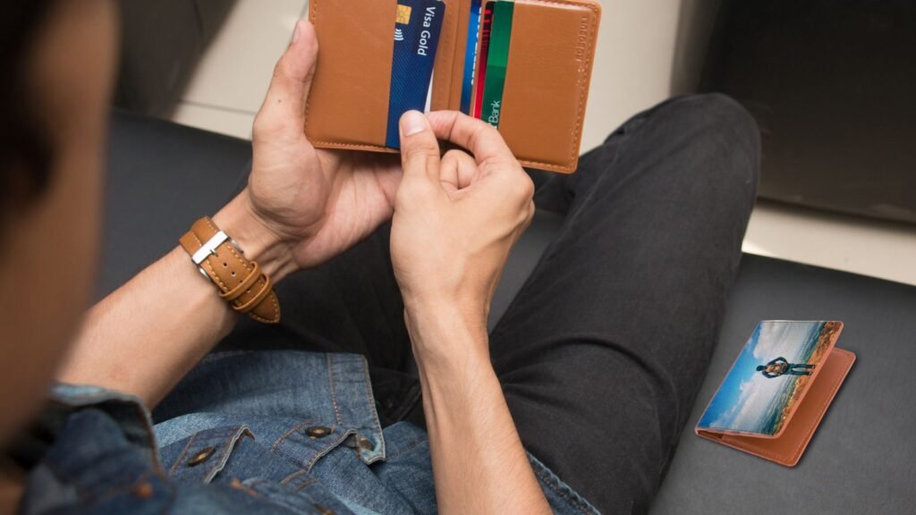 Man holding a wallet with an ID card and cards, representing replacing a lost or damaged Emirates ID