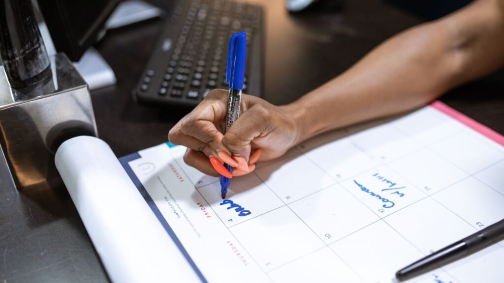 Office desk with a calendar being marked, representing planning around UAE public holidays and overtime pay rules