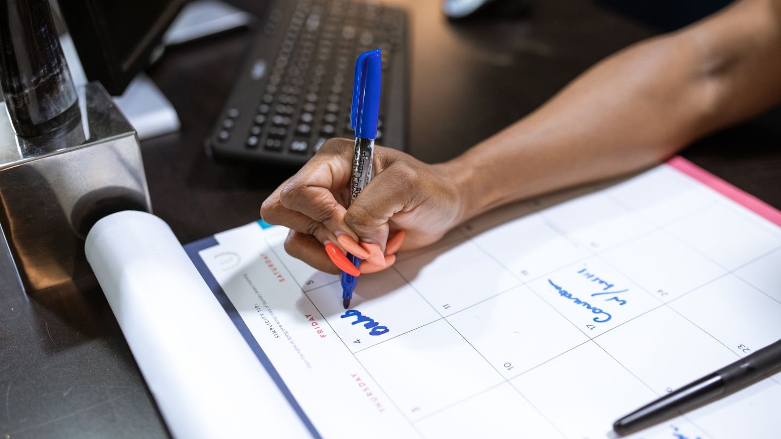 Office desk with a calendar being marked, representing planning around UAE public holidays and overtime pay rules