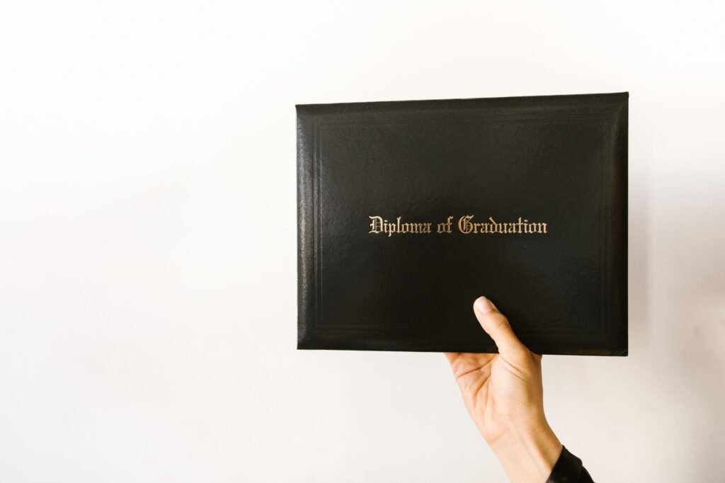 Close-up of a hand holding a graduation diploma, representing UAE degree certificate equivalency and attestation