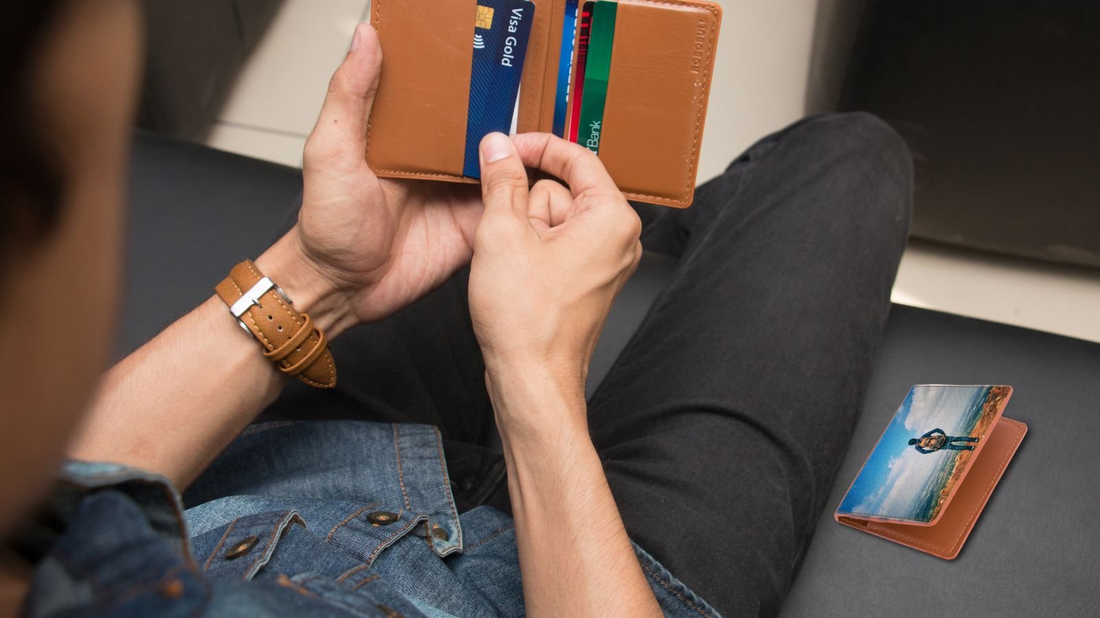 Man holding a wallet with an ID card and cards, representing replacing a lost or damaged Emirates ID