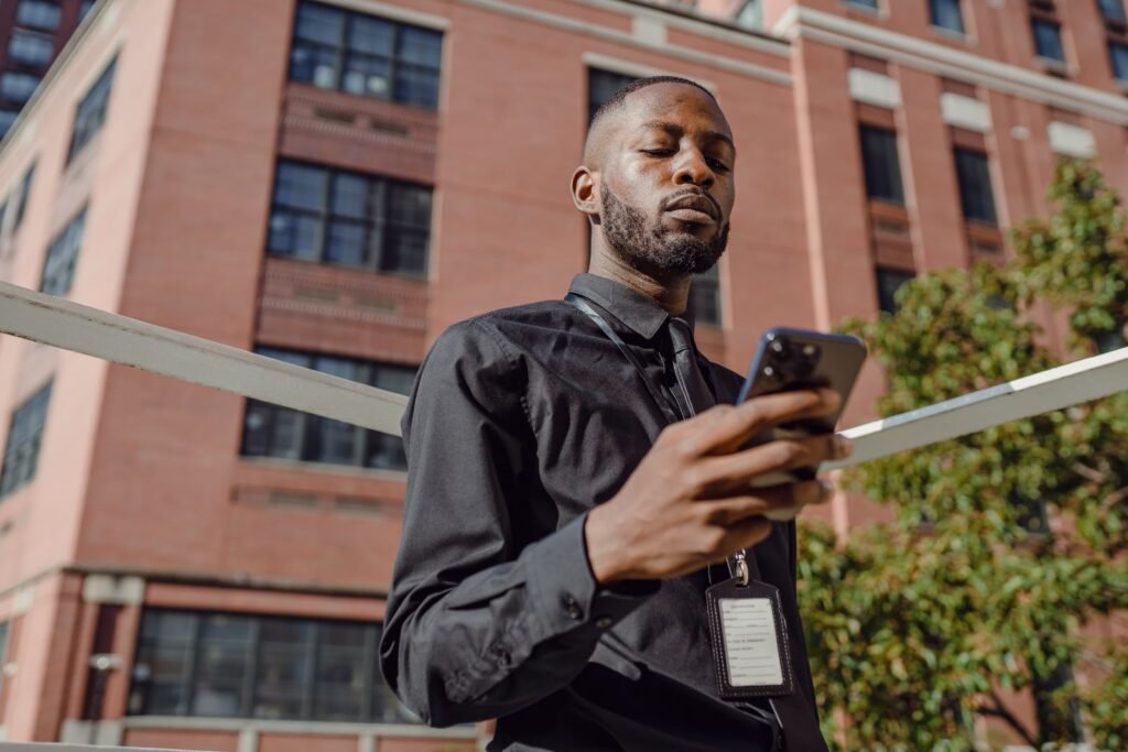 Professional using a smartphone with an ID card, representing UAE Pass digital ID registration for government services