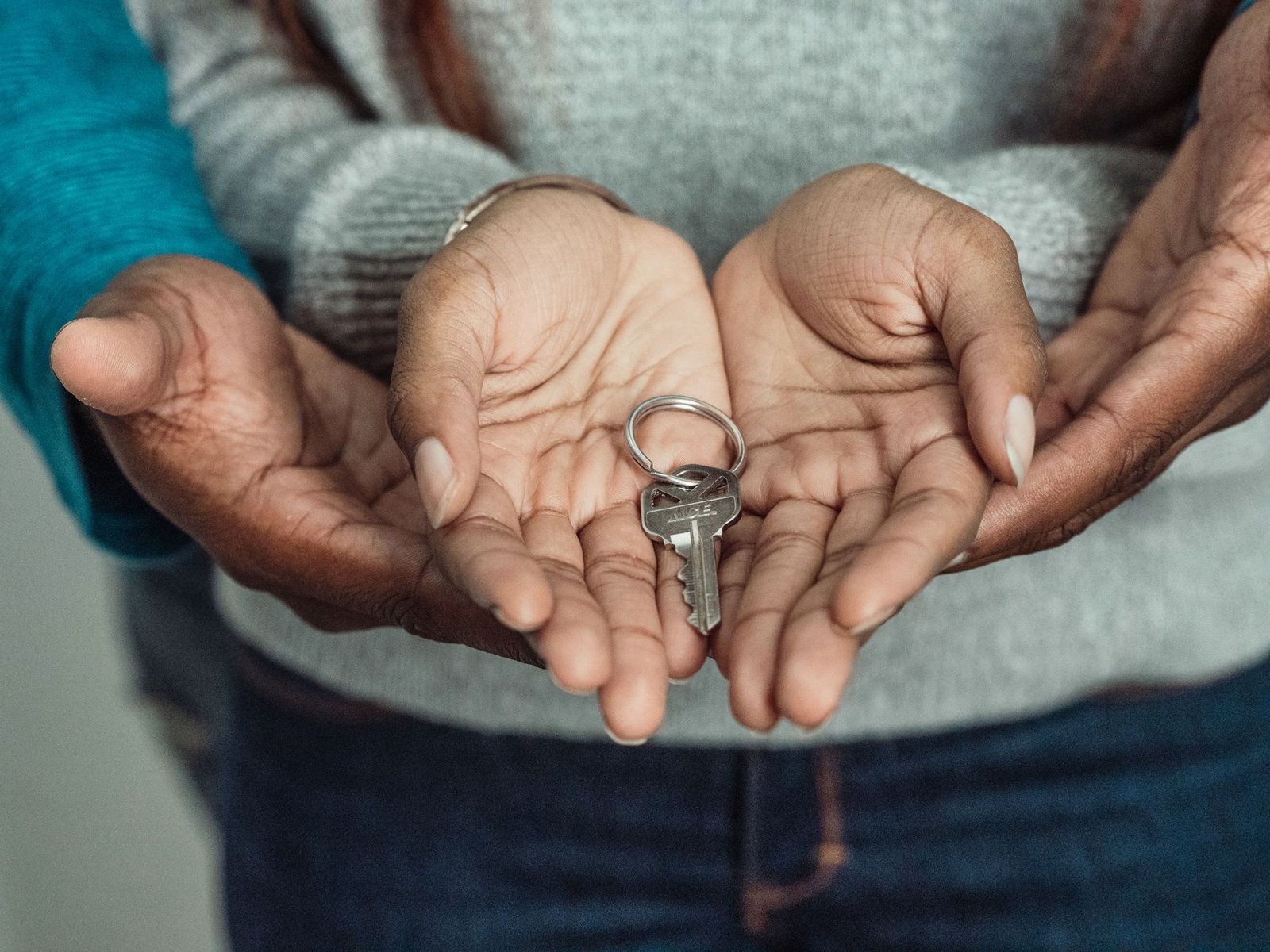 Hands holding a house key, representing a tenant and landlord rental dispute in Dubai