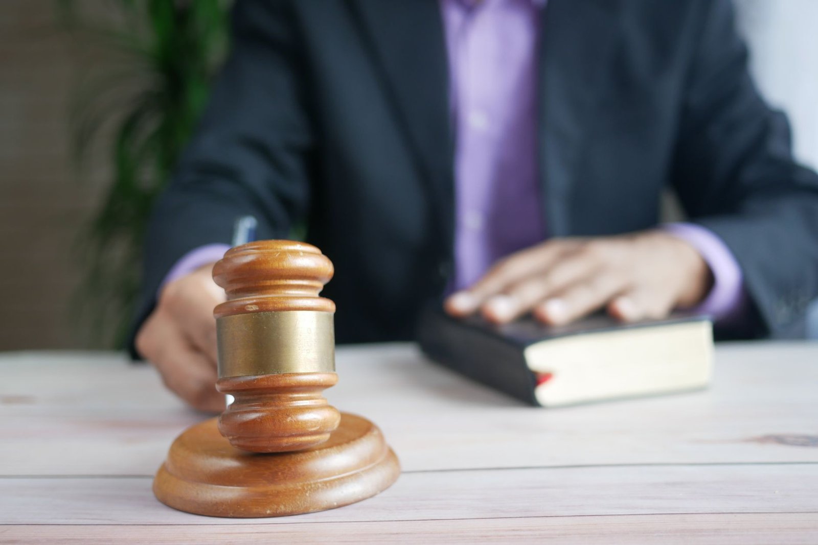 Wooden gavel and legal book on a desk, representing the small claims route for recovering unpaid money in Dubai
