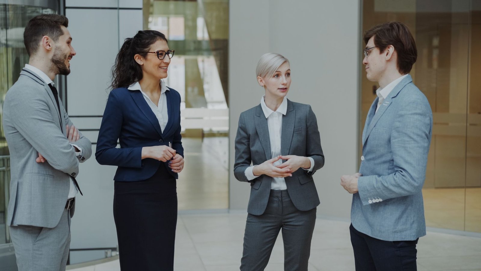 Group of business professionals discussing company staffing in a modern office, illustrating MOHRE company classification