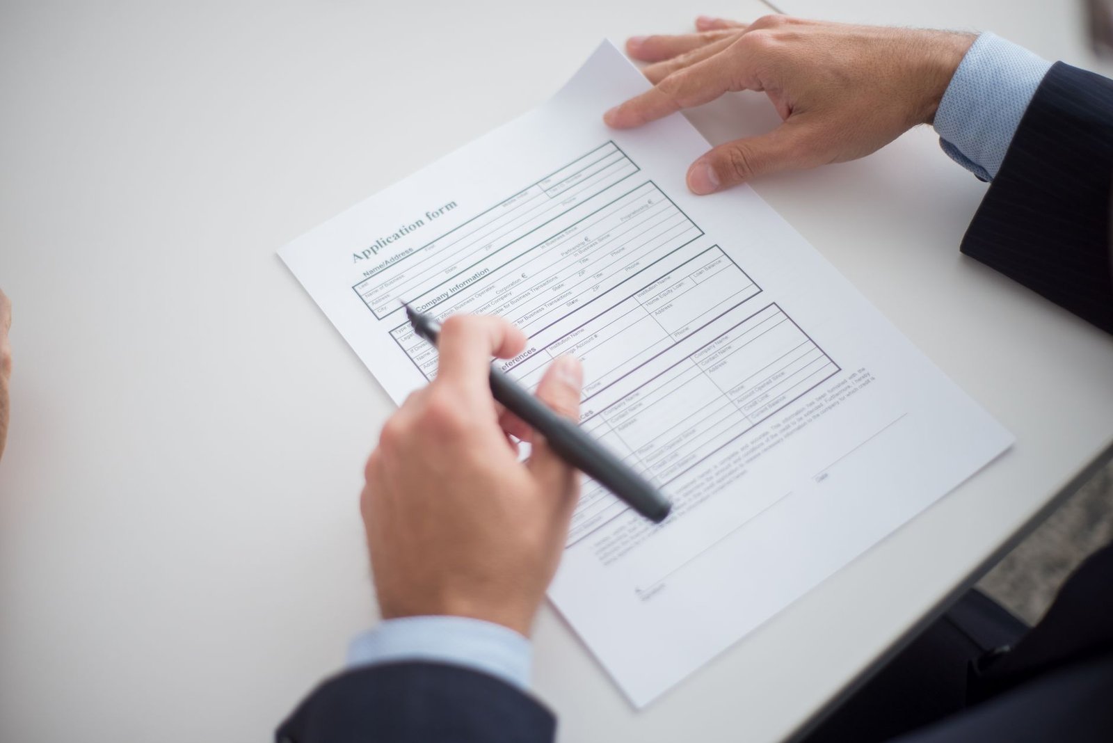 Professional reviewing a visa application form at a desk